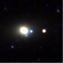 Telescope image with orbs of light in white, blue, and light yellow. 