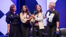  From left, actress Maisie Williams, Korion Health co-founders Akshaya Anand ’19, M.P.S. ’23 and Anna Li, and Hult Prize CEO Lori van Dam share the stage as the startup was named the $1 million winner at the London finals in early September.  Photos courtesy of the Hult Prize Foundation