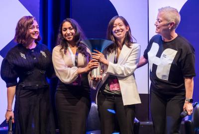  From left, actress Maisie Williams, Korion Health co-founders Akshaya Anand ’19, M.P.S. ’23 and Anna Li, and Hult Prize CEO Lori van Dam share the stage as the startup was named the $1 million winner at the London finals in early September.  Photos courtesy of the Hult Prize Foundation