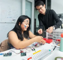 Professor and student collaborating on wearable device