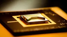 A chip containing an ion trap that researchers use to capture and control atomic ion qubits (quantum bits). (Credit: Kai Hudek/JQI)