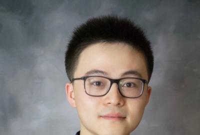 Assistant Professor in Computer Science Ruohan Gao in dark shirt and glasses.