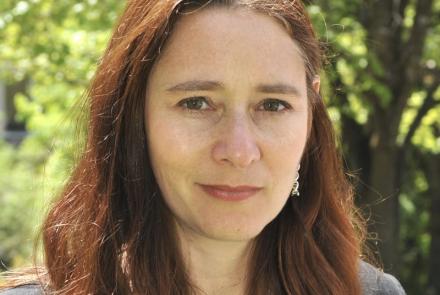 Outdoor portrait of brunette woman, Dr. Allison Coffin.