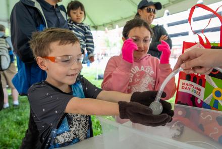 Kids participating in an experiment at Maryland Day 2025
