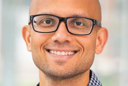 Pratyush Tiwary in glasses and a blue-checked shirt.