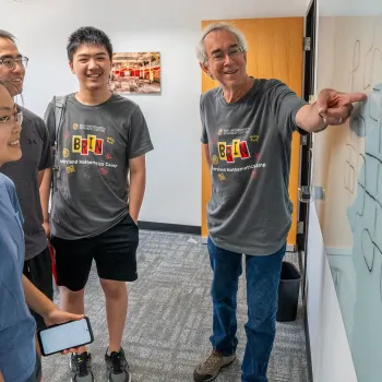 Professor Larry Washington works with students attending the first year of the Brin Maryland Mathematics Camp in 2024