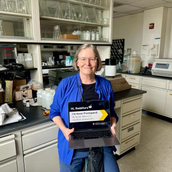 Karen Prestegaard holding a laptop in her lab