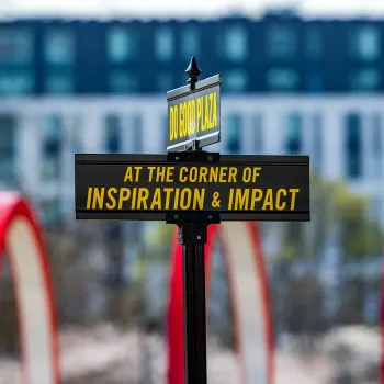 Road signs that read "Do Good Plaza" and "At the Corner of Inspiration & Impact"