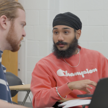 Harkeerat Sing having a discussion with another student