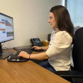 Sarah Wiegreffe sits at a computer, examining whether the reasoning processes used by advanced AI systems will remain transparent 