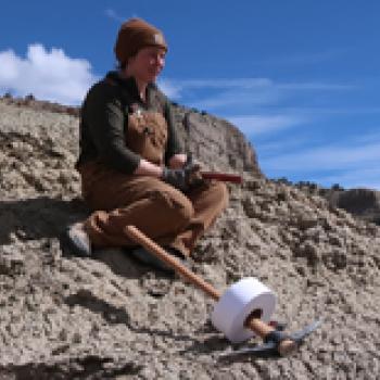 gussie mccracken sitting on a rock