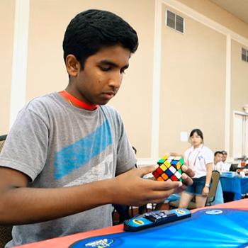 Pavan Ravindra solving a Rubik's Cube in competition.