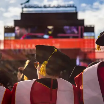 Image of UMD students at graduation in caps and gowns