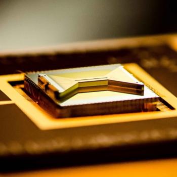 A chip containing an ion trap that researchers use to capture and control atomic ion qubits (quantum bits). (Credit: Kai Hudek/JQI)