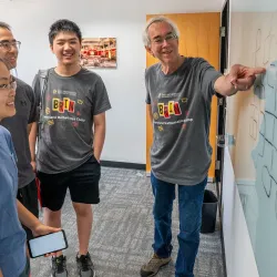 Professor Larry Washington works with students attending the first year of the Brin Maryland Mathematics Camp in 2024