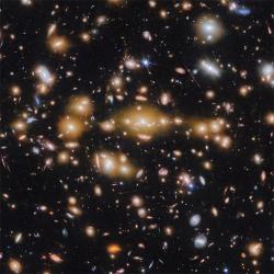 A view of the Cosmic Gems arc compared to a wide-field view of many galaxies against a black background