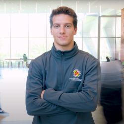 Hayden Earlewine wearing a gray CMNS quarter zip