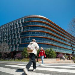 Exterior of Iribe Center building with people walking across the street