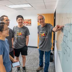 Larry Washington pointing to a whiteboard