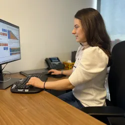 Sarah Wiegreffe sits at a computer, examining whether the reasoning processes used by advanced AI systems will remain transparent 