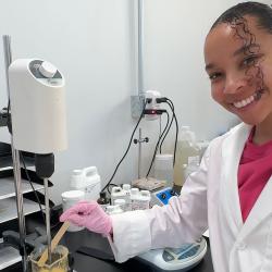 Kaia Ungerer posing in a chemistry lab