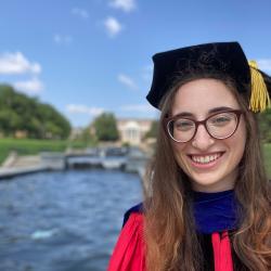 Jessica Kopew in her red UMD doctorate cap and gown.