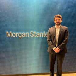 Nathan Frohna next to Morgan Stanley sign. Image courtesy of same.