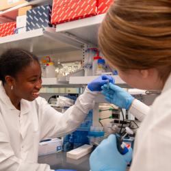 Ademide Adeyemo and Caroline Hobson collaborate at the lab bench.