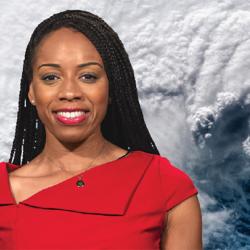 Monique Robinson in a red dress, standing in front of a satellite photo of Hurricane Florence.