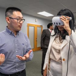 Sida Li with Lt. Gov. Miller wearing a VR headset