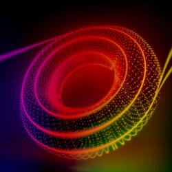 A new technique sees two distinct particles of light enter a chip and two identical twin particles of light leave it. The image artistically combines the journey of twin particles of light along the outer edge of a checkerboard of rings with the abstract shape of its topological underpinnings. (Credit: Kaveh Haerian)