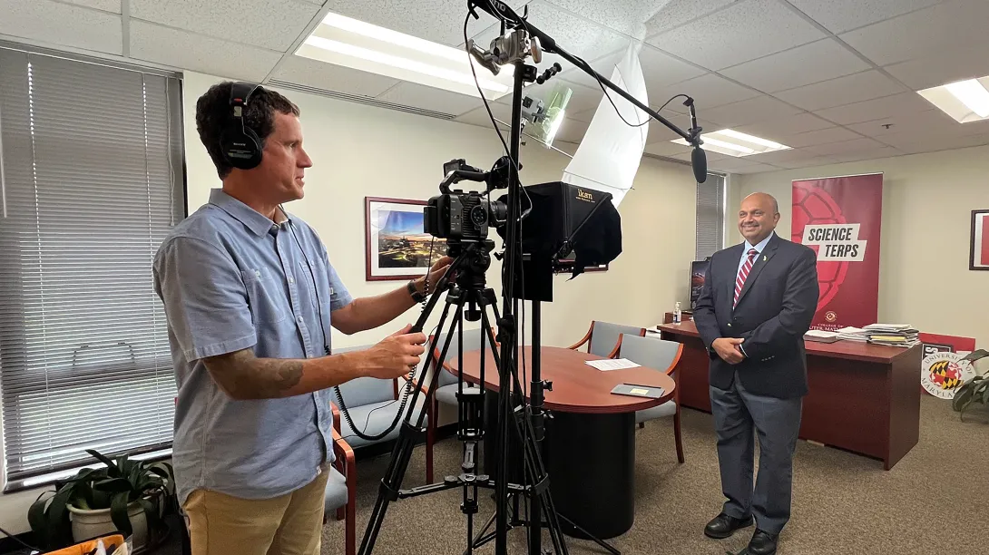 Person recording a video of the dean in his office