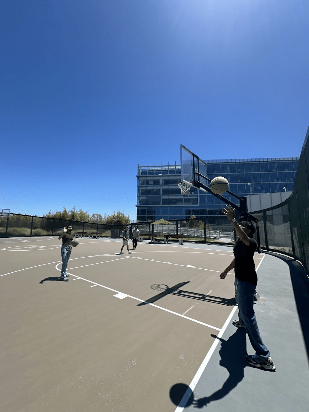 Gorthy playing basketball with fellow interns